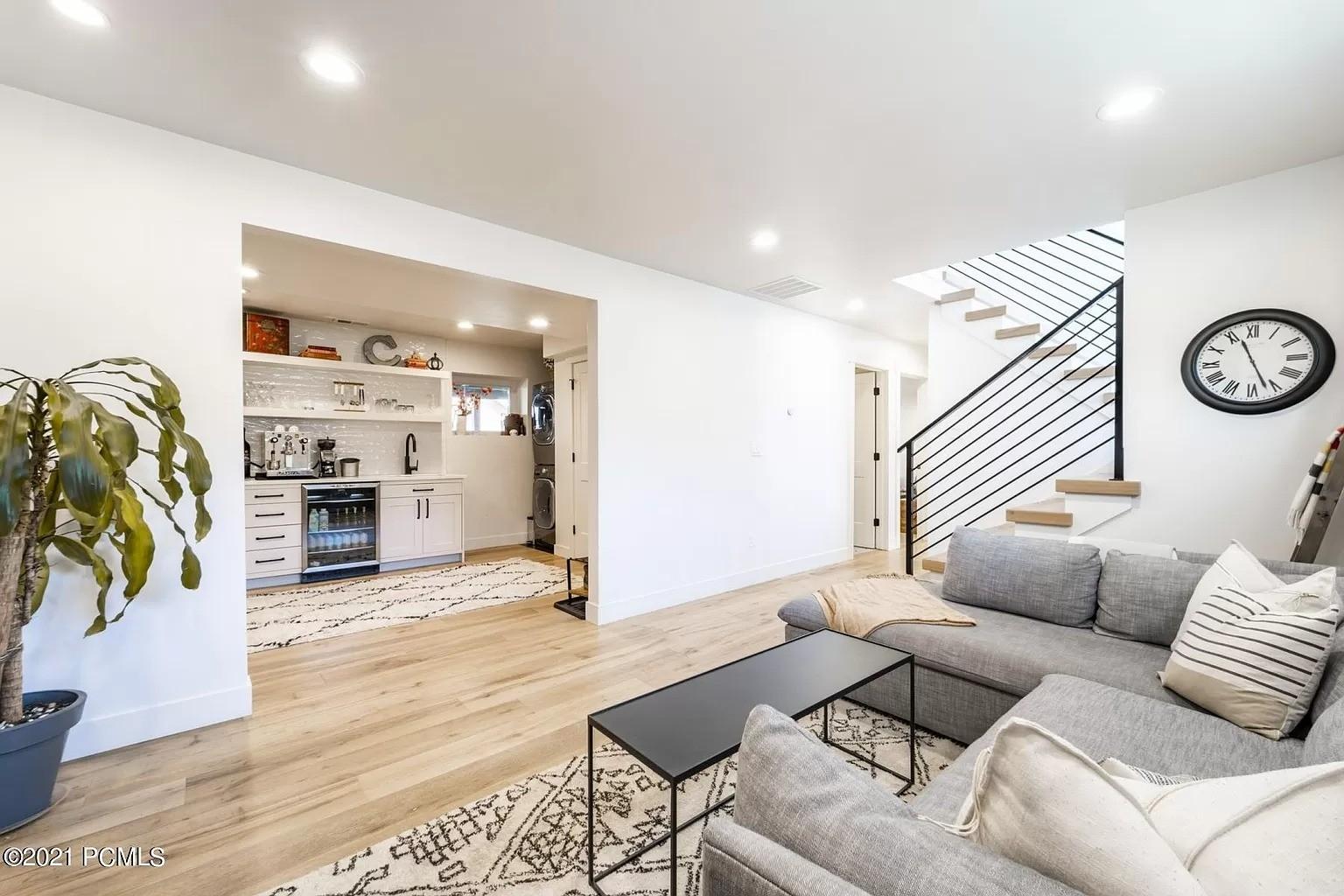 A living room filled with furniture and a staircase