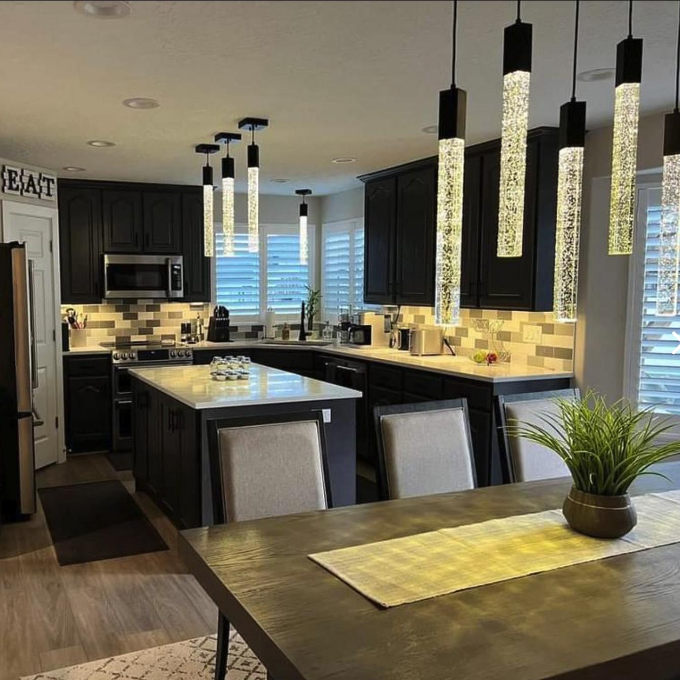 A kitchen with a center island and a dining room table