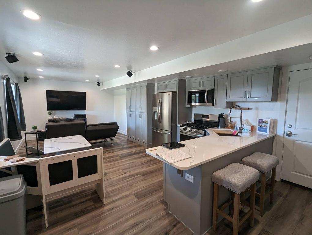 A kitchen with a center island with stools