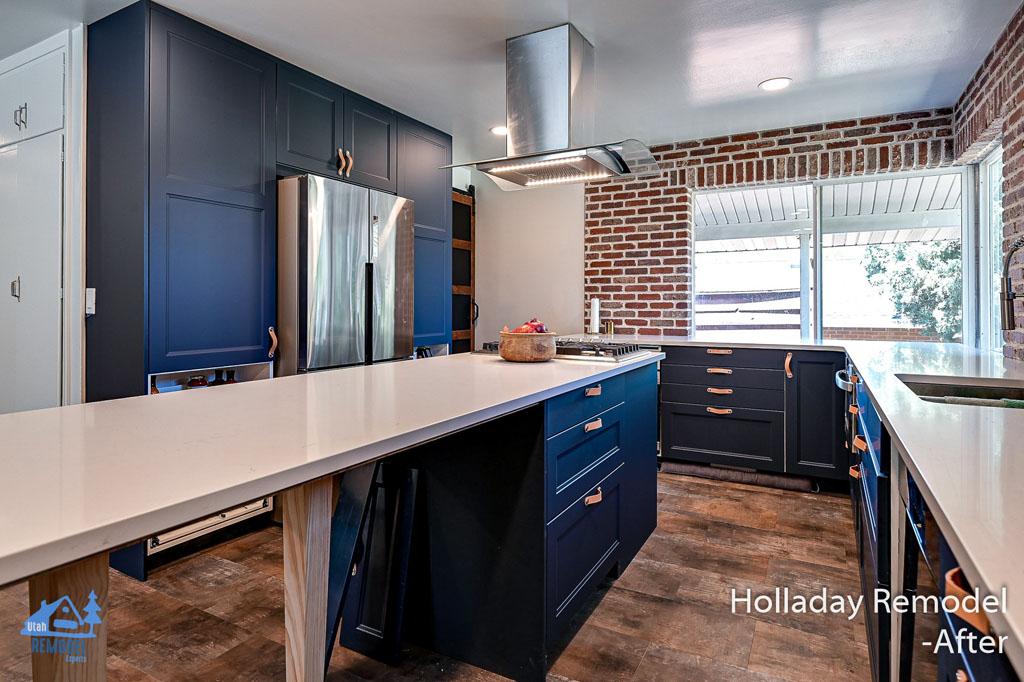 A kitchen with blue cabinets and white counter tops