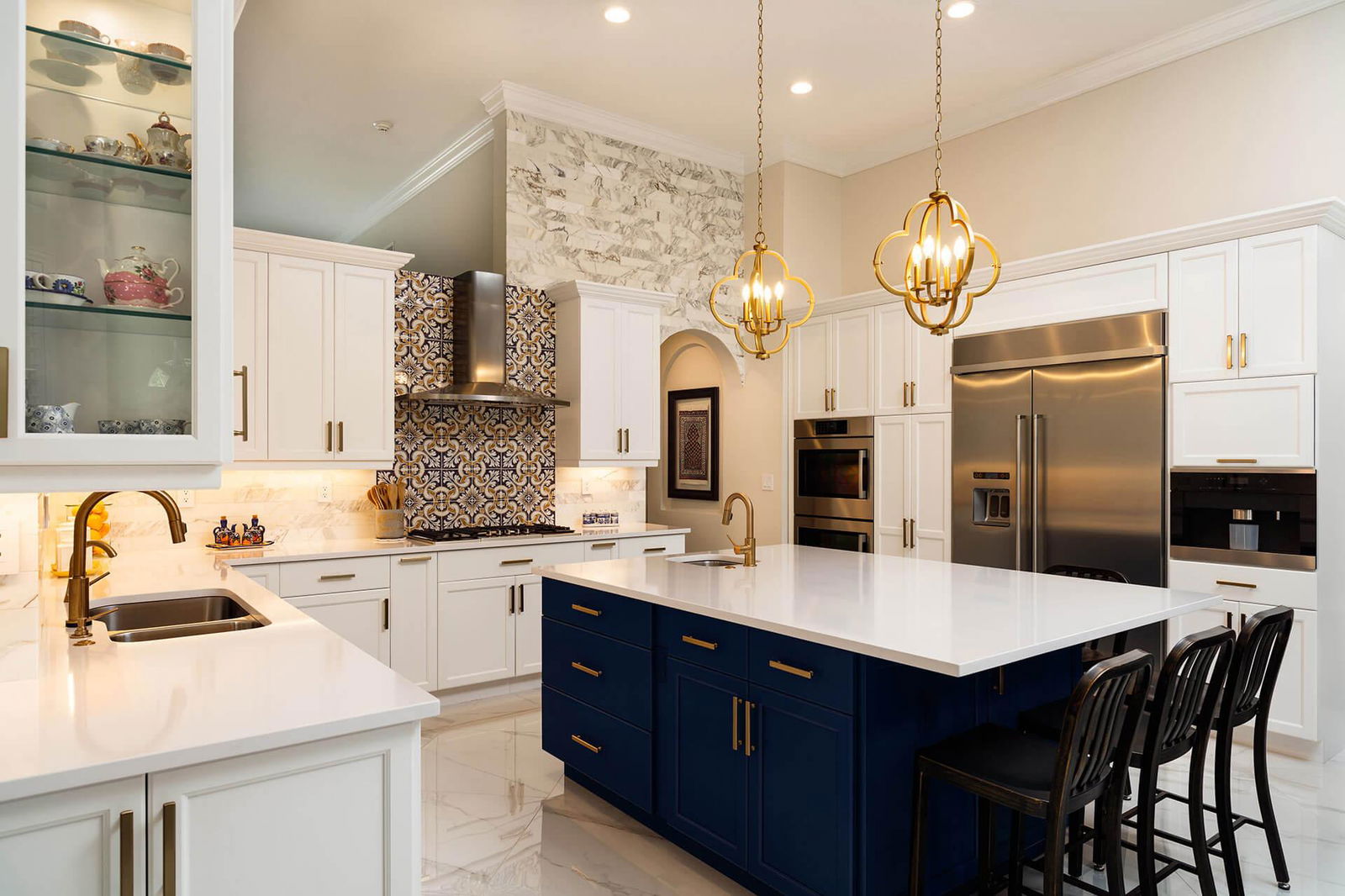 A kitchen with white cabinets and a blue island