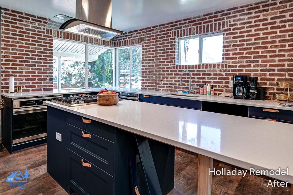 A kitchen with a stove, sink, oven and microwave