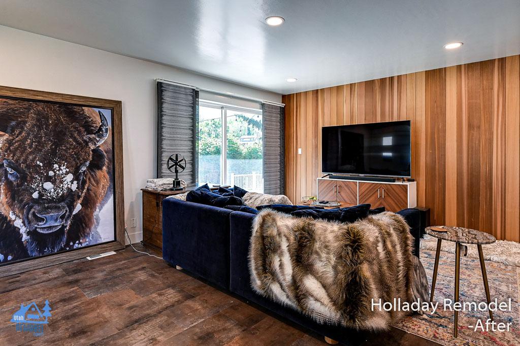 A living room filled with furniture and a painting on the wall