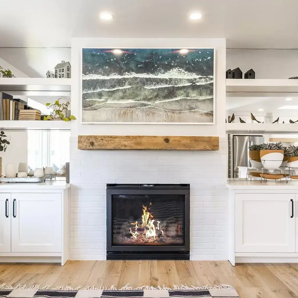 A living room with a fire place and white cabinets