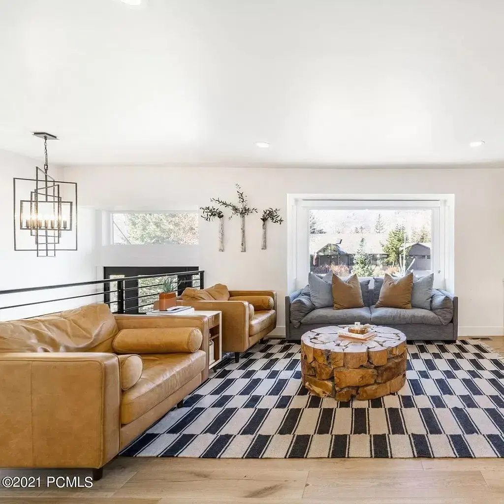 A living room filled with furniture and a checkered rug