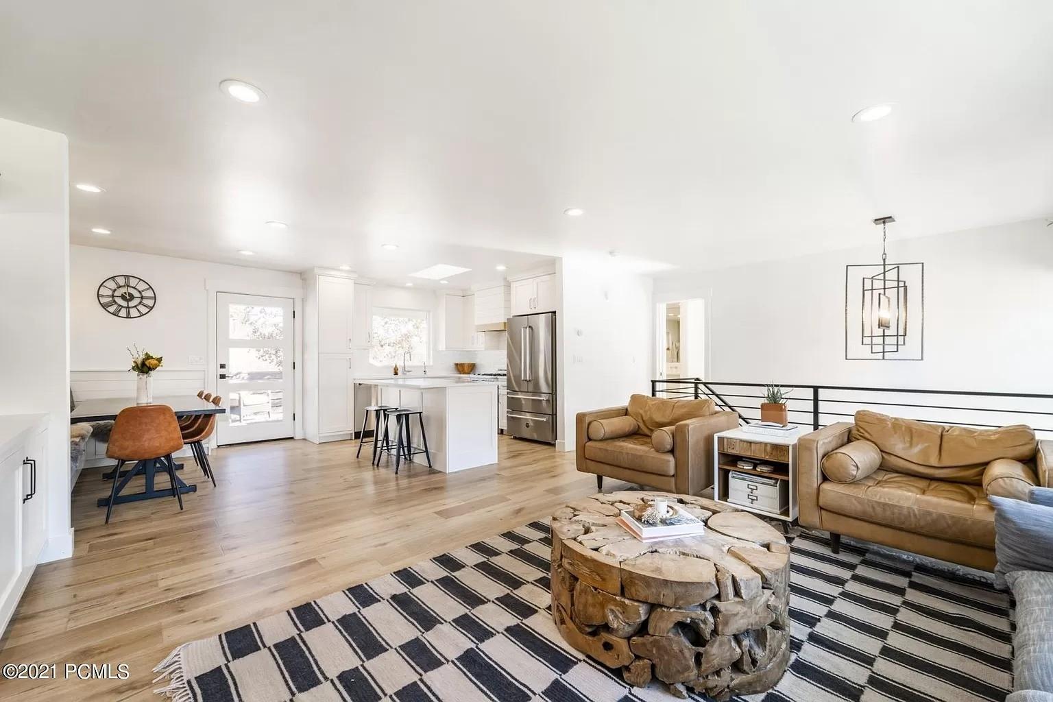 A living room filled with furniture next to a kitchen