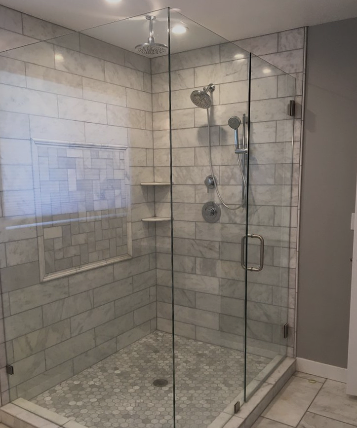 A walk in shower with a glass door