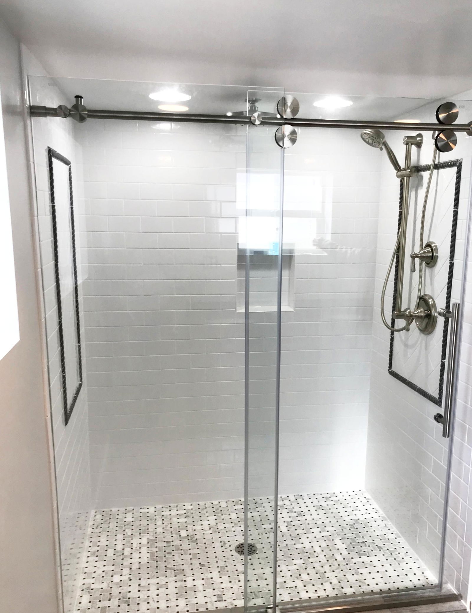 A walk in shower with a glass door