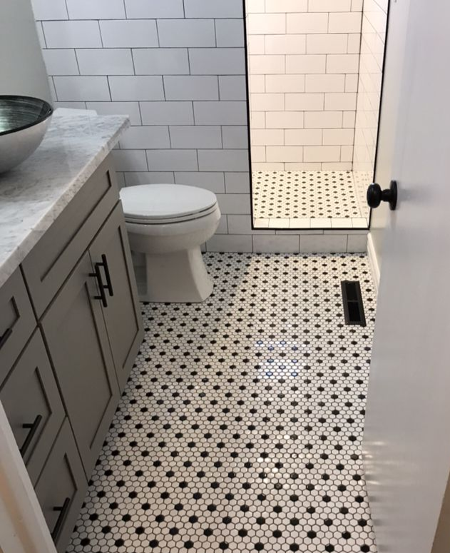 A white toilet sitting next to a walk in shower