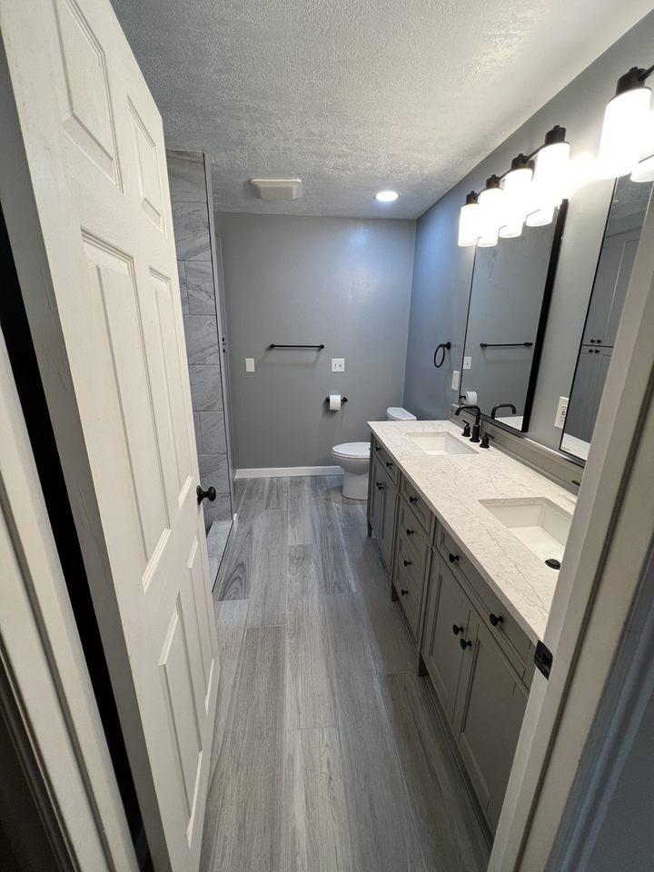 A bathroom with two sinks and a large mirror