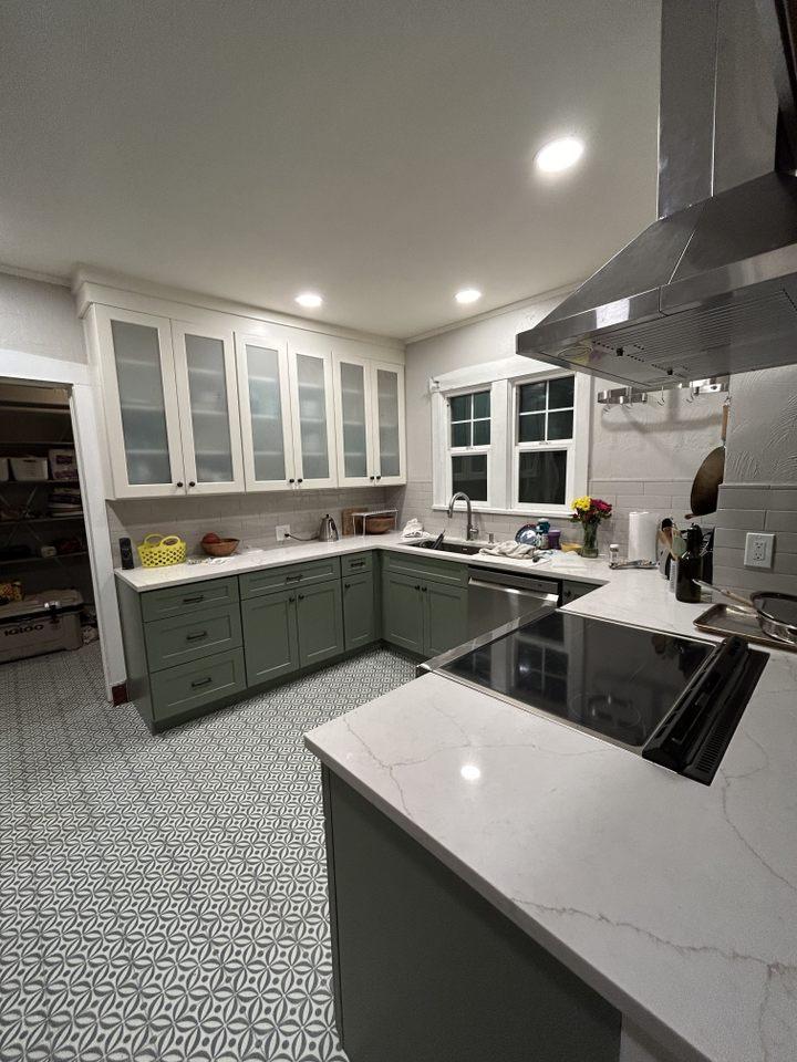 A kitchen with a stove top oven and a sink