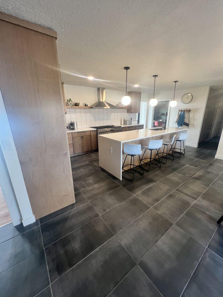 A kitchen with a center island and bar stools